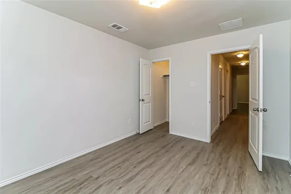 wooden floor in a hall with an empty room