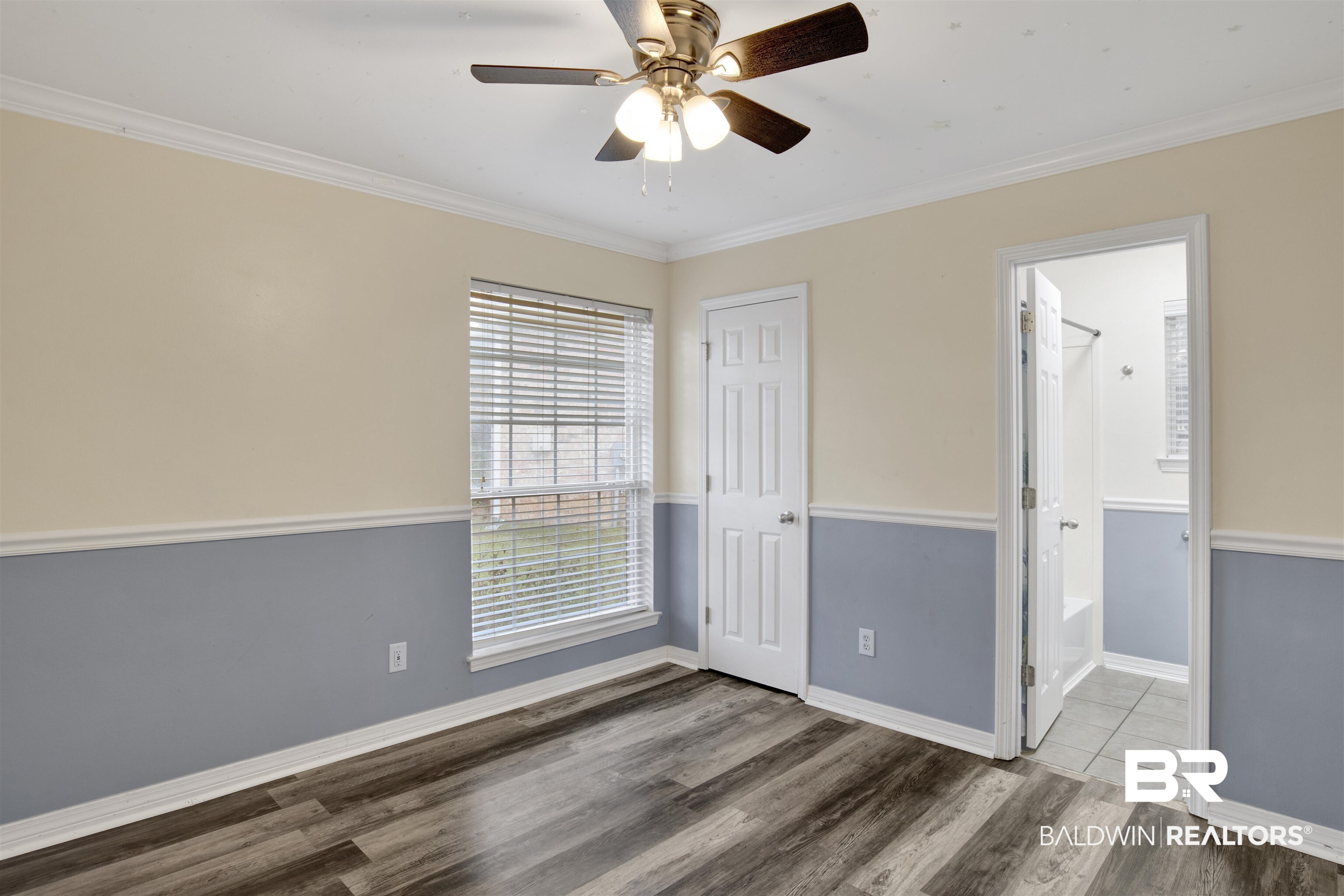 9534 Labrador Run North Mobile, AL 36695 - Photo 16 of 30 Unfurnished bedroom with crown molding, wood finished floors, a ceiling fan, ensuite bathroom, and a closet