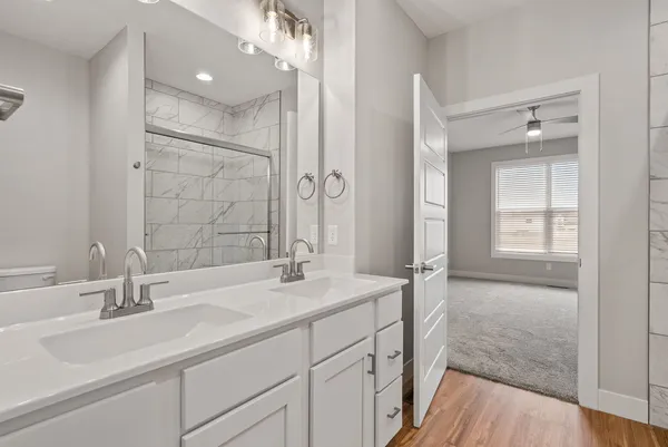 a bathroom with a sink and a mirror with bathtub
