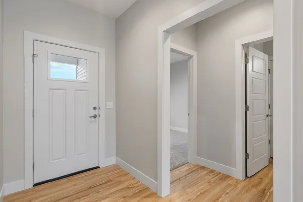 a view of hallway with wooden floor