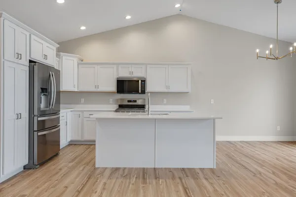 a kitchen with stainless steel appliances a refrigerator microwave and stove