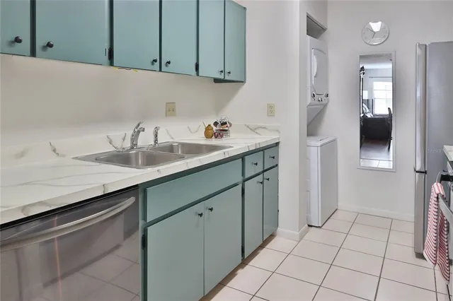 a kitchen with a sink and refrigerator