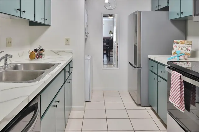 a kitchen with stainless steel appliances granite countertop a refrigerator and a sink