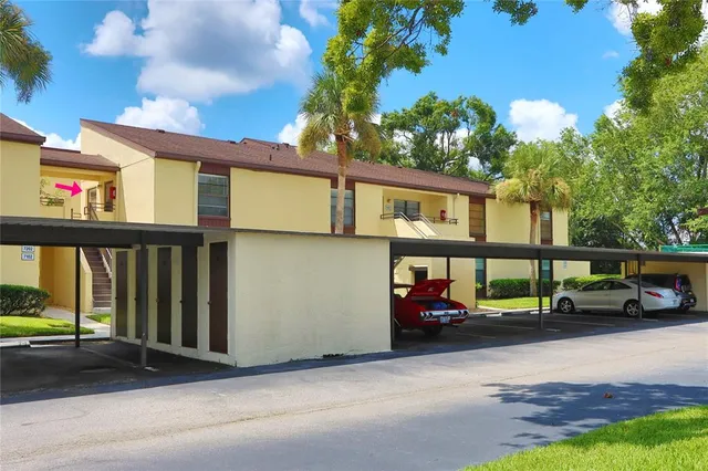 a front view of a house with a yard and fountain in middle