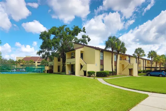 a view of a house with swimming pool and sitting area