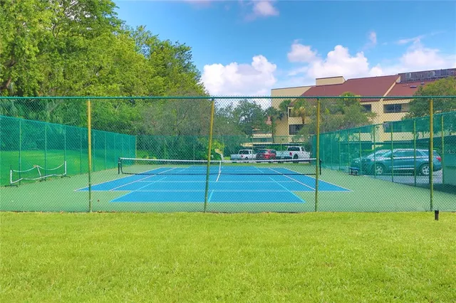 a view of a fence and white wall