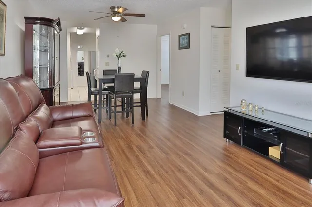 a living room with furniture a dining table and a chandelier