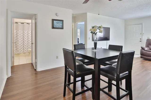 a view of a dining room with furniture and wooden floor