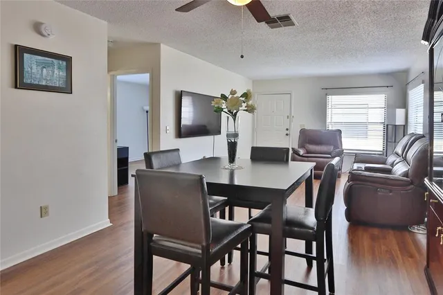 a view of a dining room with furniture and wooden floor