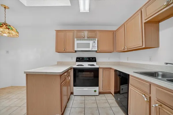 a kitchen with a sink stove and cabinets