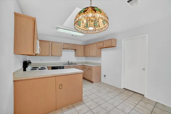 a kitchen with cabinets and steel stainless steel appliances