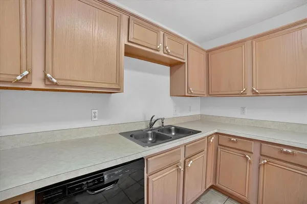 a kitchen with stainless steel appliances granite countertop white cabinets and a sink
