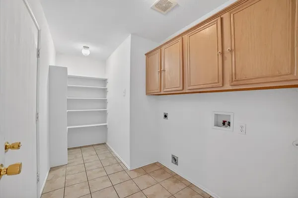 a view of storage and utility room with cabinet