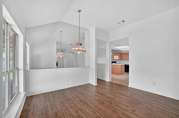 a view of empty room and wooden floor