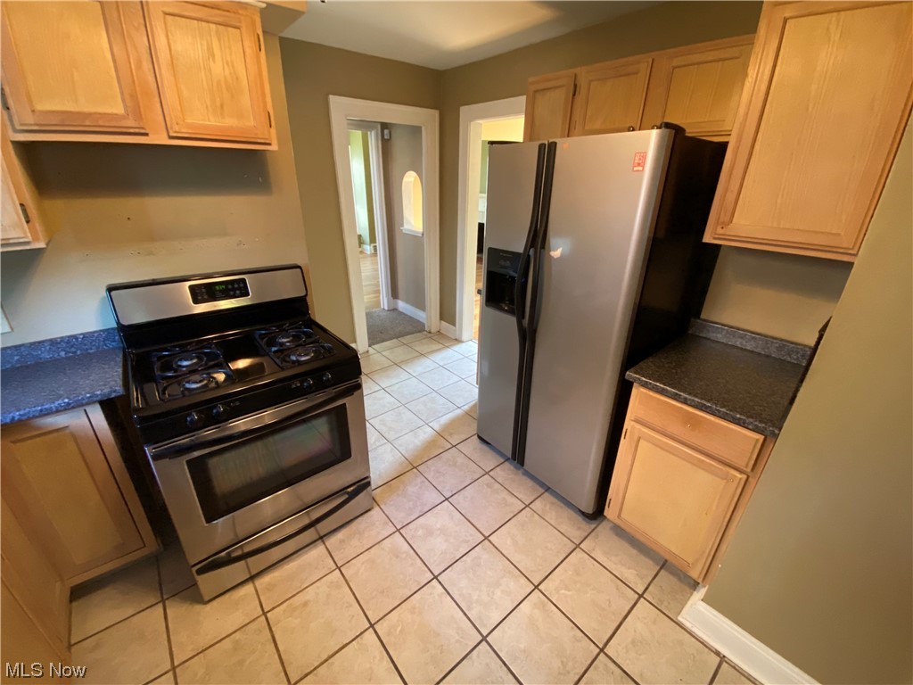 3630 Bainbridge Road Cleveland Heights, OH 44118 - Photo 9 of 21 Kitchen with light tile flooring, light brown cabinetry, and stainless steel appliances