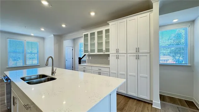a large kitchen with stainless steel appliances granite countertop a stove a sink and a microwave