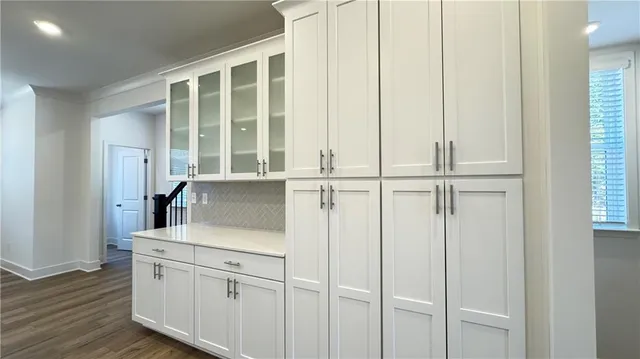 a view of a kitchen with a refrigerator and a stove top oven