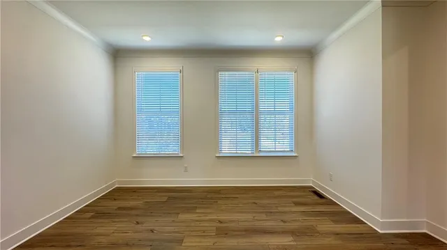 a view of staircase with white walls and railing