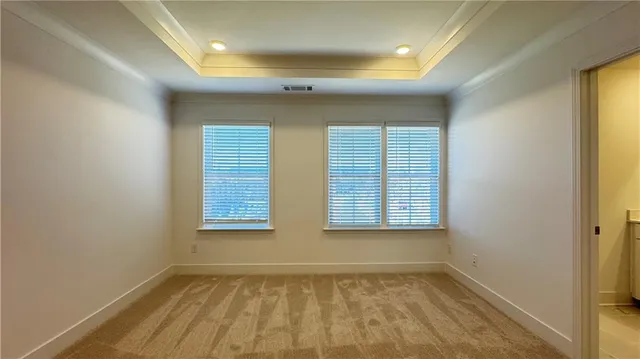 an empty room with closet and wooden door