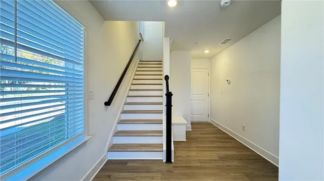 a kitchen with counter top space and windows