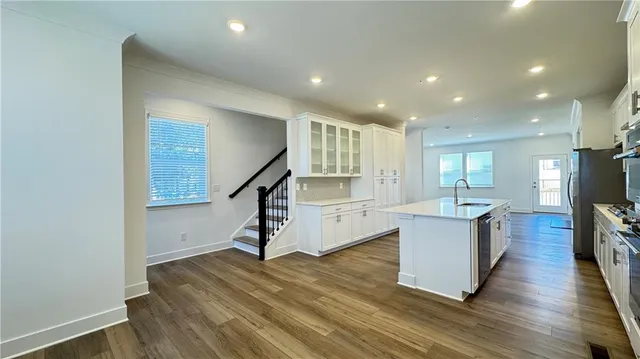 a kitchen with stainless steel appliances a sink a stove and a refrigerator
