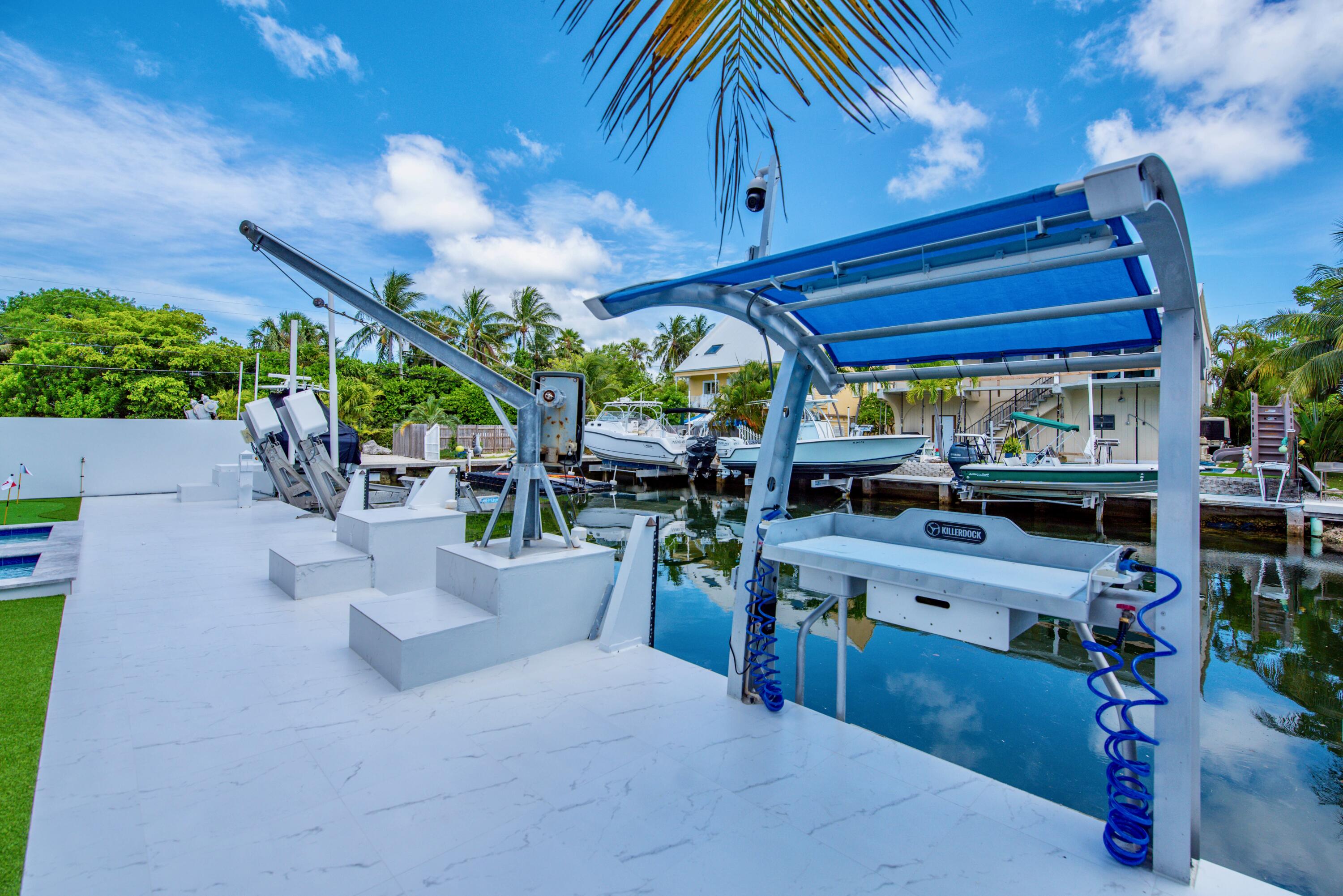 3 Evergreen Avenue Key Haven, FL 33040 - Photo 22 of 75 a view of a patio with a table and chairs under an umbrella