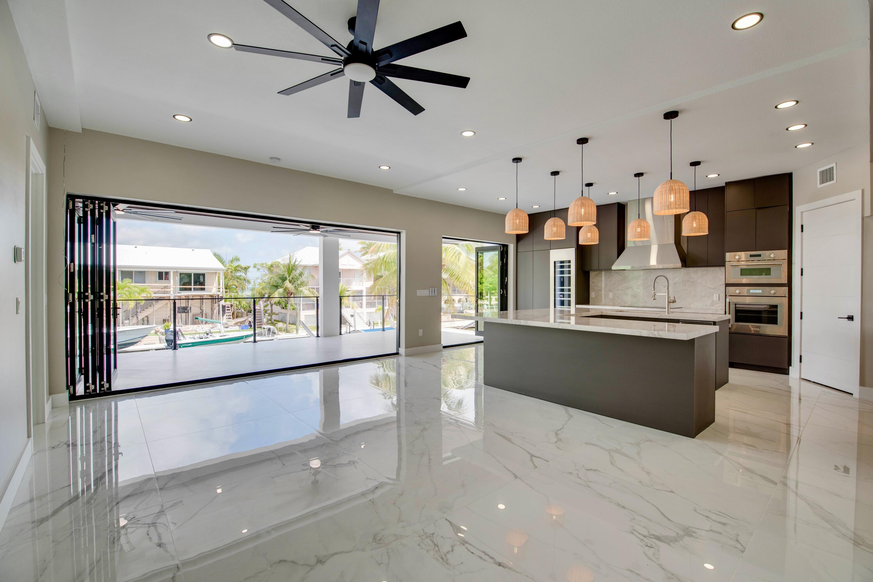 3 Evergreen Avenue Key Haven, FL 33040 - Photo 25 of 75 a large kitchen with stainless steel appliances kitchen island a large counter top a stove and a shower