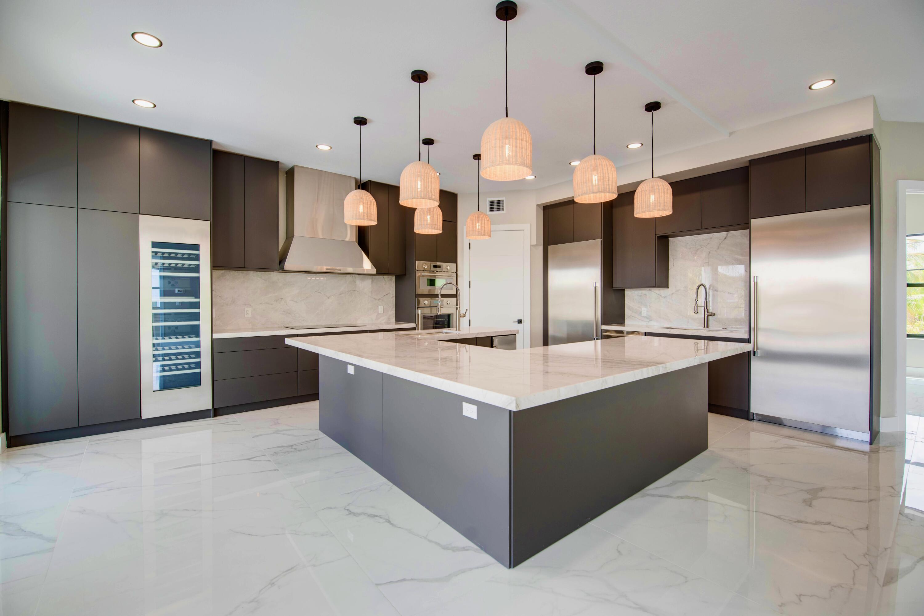 3 Evergreen Avenue Key Haven, FL 33040 - Photo 27 of 75 a large kitchen with kitchen island a large counter top a sink and stainless steel appliances