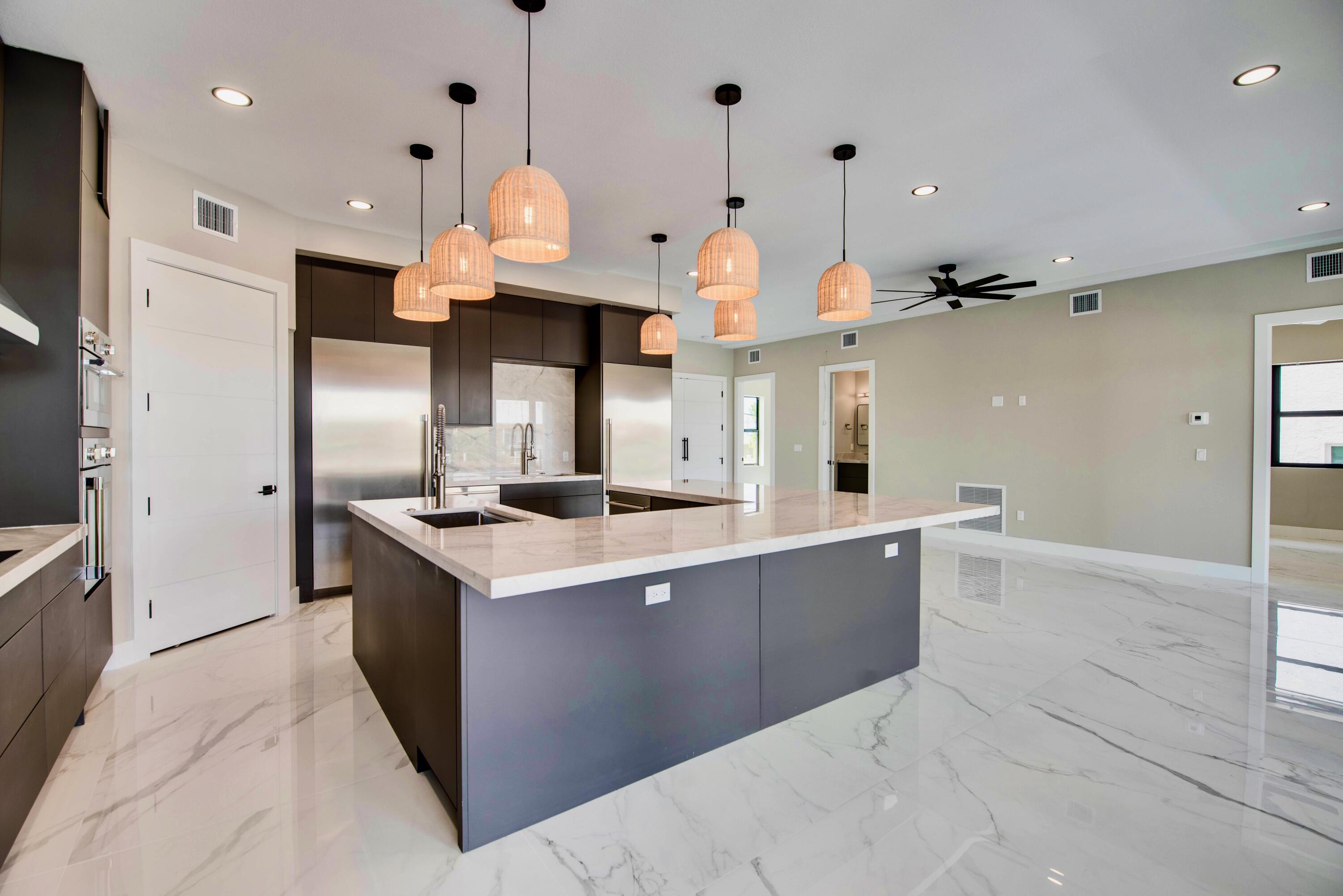 3 Evergreen Avenue Key Haven, FL 33040 - Photo 28 of 75 a kitchen with stainless steel appliances granite countertop a sink and a refrigerator