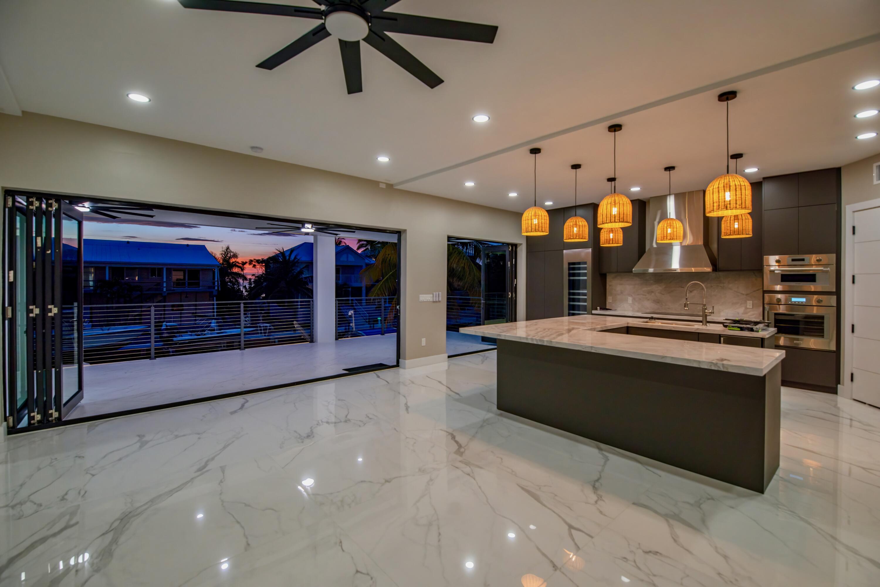 3 Evergreen Avenue Key Haven, FL 33040 - Photo 51 of 75 a large living room with stainless steel appliances kitchen island granite countertop a large kitchen a sink and a large window