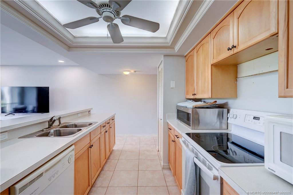 5539 Northeast Gulfstream Way Stuart, FL 34996 - Photo 11 of 26 a kitchen with stainless steel appliances granite countertop a sink and a stove top oven