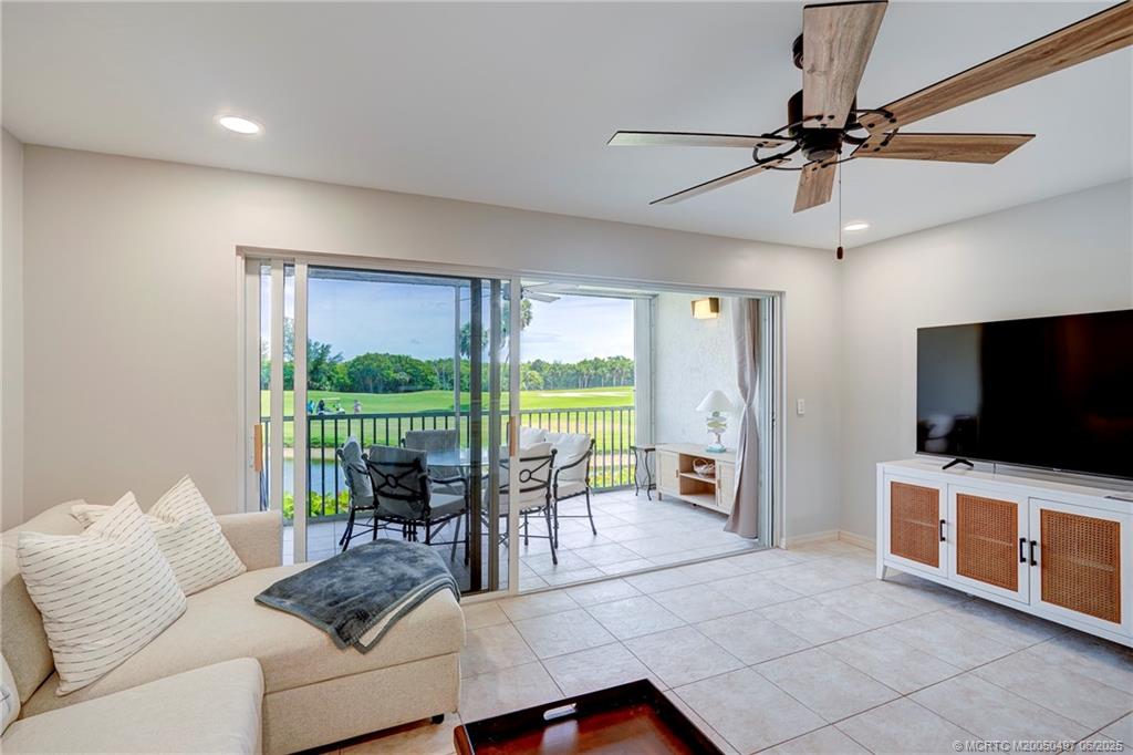 5539 Northeast Gulfstream Way Stuart, FL 34996 - Photo 15 of 26 a living room with furniture a flat screen tv and a large window