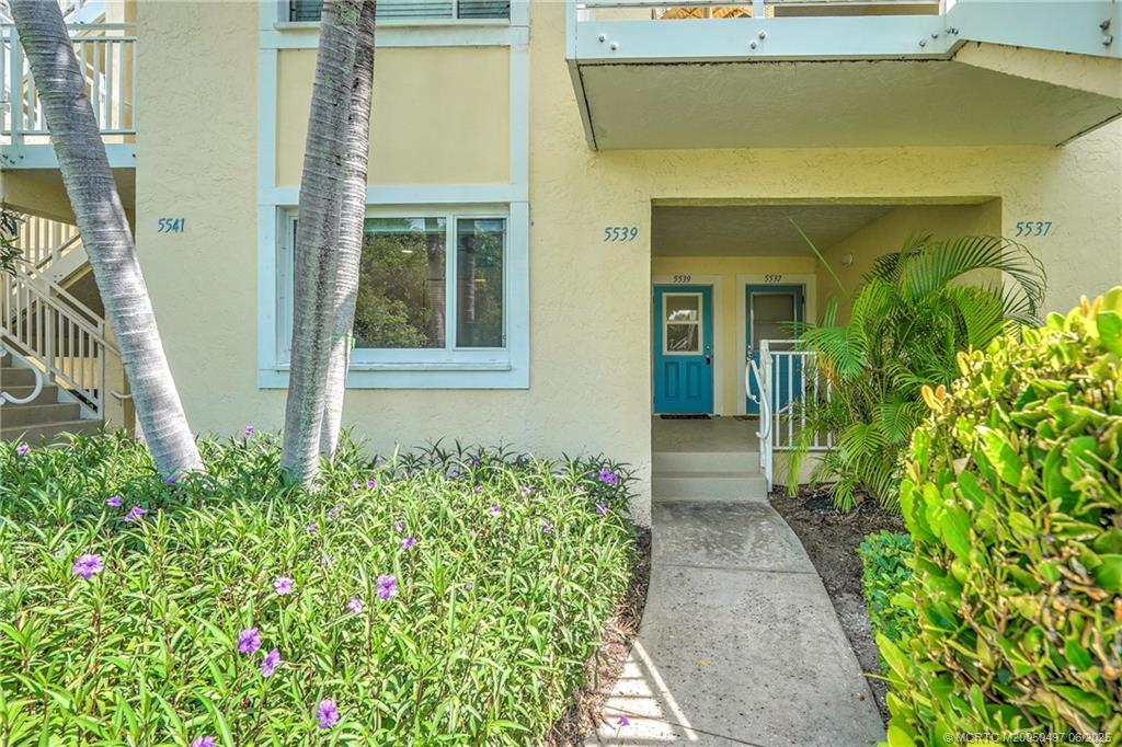 5539 Northeast Gulfstream Way Stuart, FL 34996 - Photo 2 of 26 front view of a house with a yard