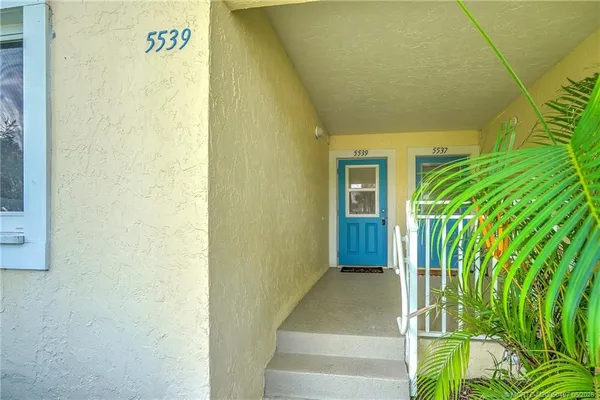 a view of a room with furniture and wooden door