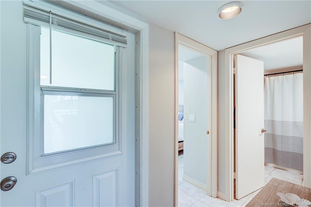 5539 Northeast Gulfstream Way Stuart, FL 34996 - Photo 5 of 26 a view of a bathroom with a glass door
