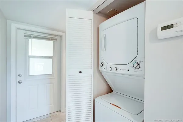 a view of a kitchen with a sink and a large window