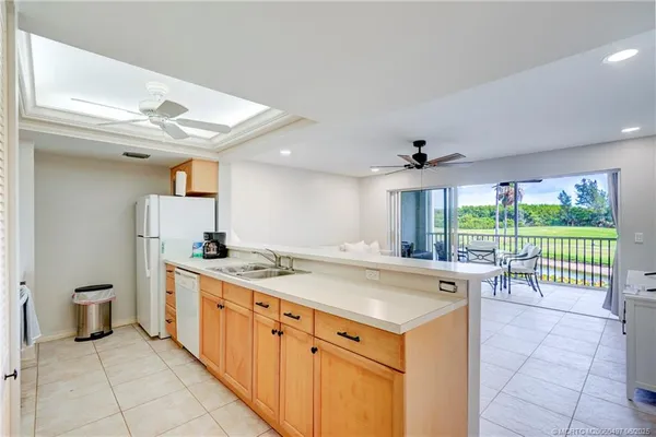 a large white kitchen with a large window