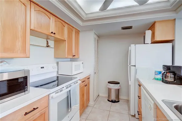 a kitchen with a sink appliances and a large window