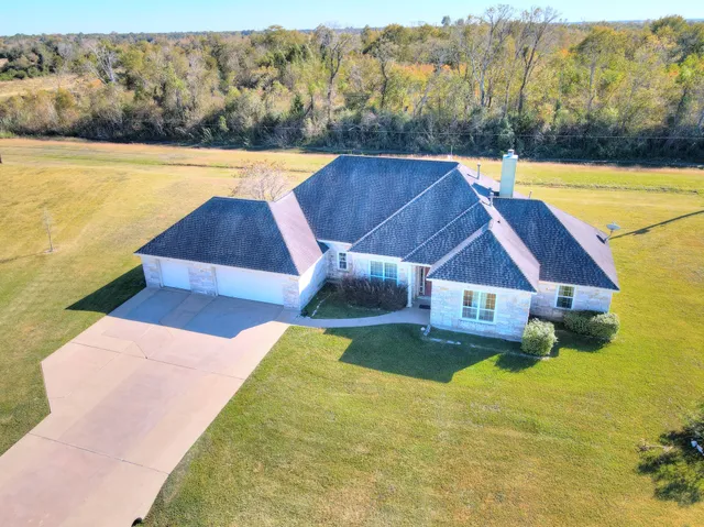 a view of a house with pool and a yard