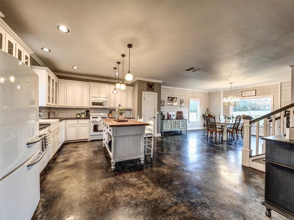 4983 Applegate Road Bowie, TX 76230 - Photo 12 of 40 a living room with lots of furniture and kitchen view