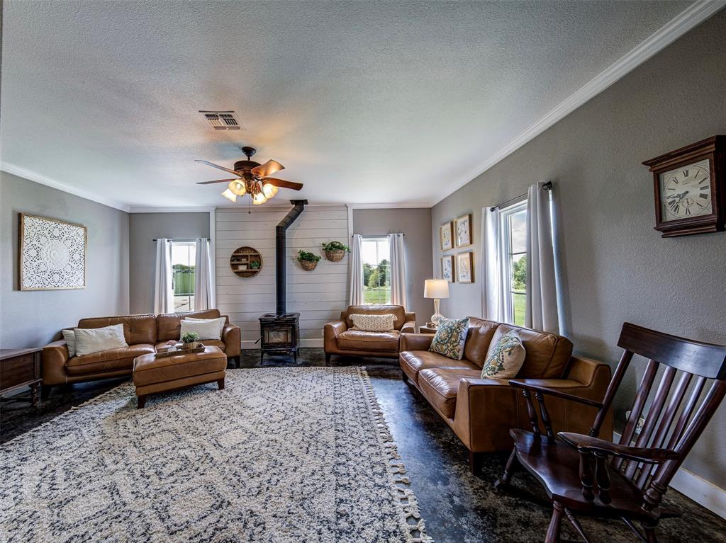 4983 Applegate Road Bowie, TX 76230 - Photo 16 of 40 a living room with furniture and a chandelier