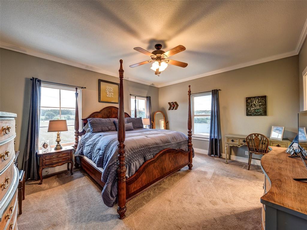4983 Applegate Road Bowie, TX 76230 - Photo 18 of 40 a spacious bedroom with a bed and dresser