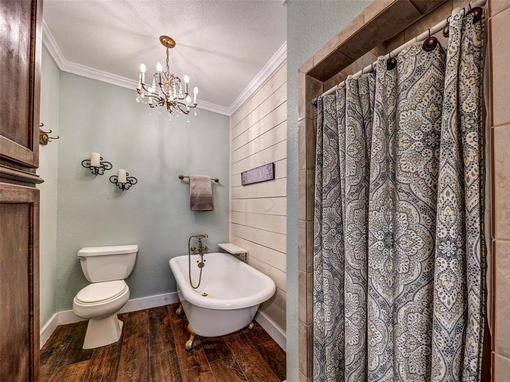 4983 Applegate Road Bowie, TX 76230 - Photo 22 of 40 a bathroom with a toilet a sink and a mirror