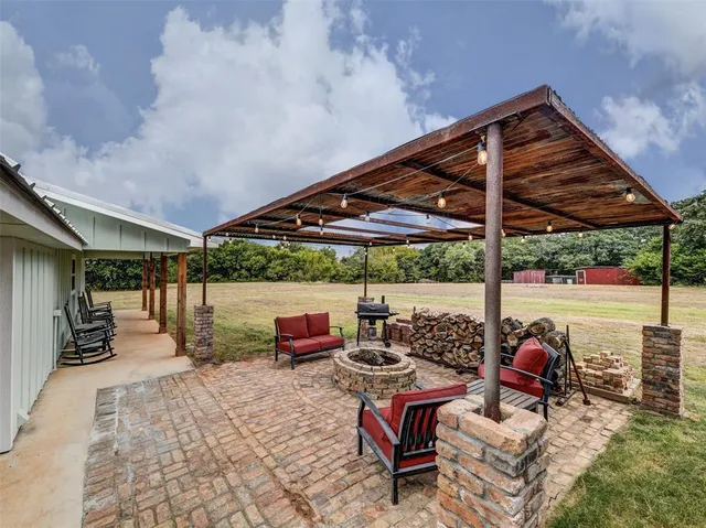 a living room with stainless steel appliances kitchen island furniture and a chandelier