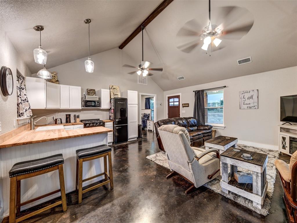 4983 Applegate Road Bowie, TX 76230 - Photo 30 of 40 a living room with stainless steel appliances kitchen island furniture and a chandelier