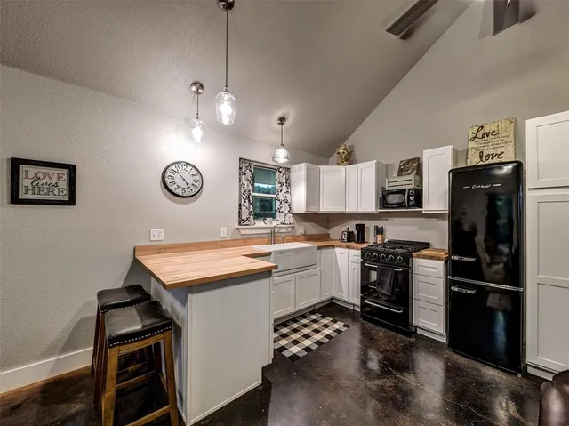a bedroom with a bed and a flat tv screen on dresser