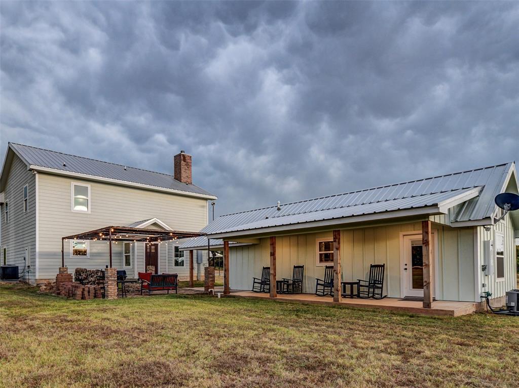 4983 Applegate Road Bowie, TX 76230 - Photo 5 of 40 a view of a house with large space and a car park in front of it