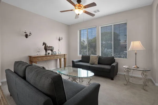 a view of a hallway and a livingroom with furniture