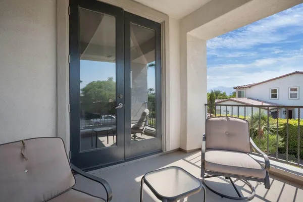 a view of a house with swimming pool and sitting area
