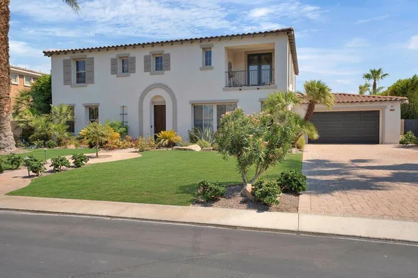 a front view of house with yard and outdoor seating